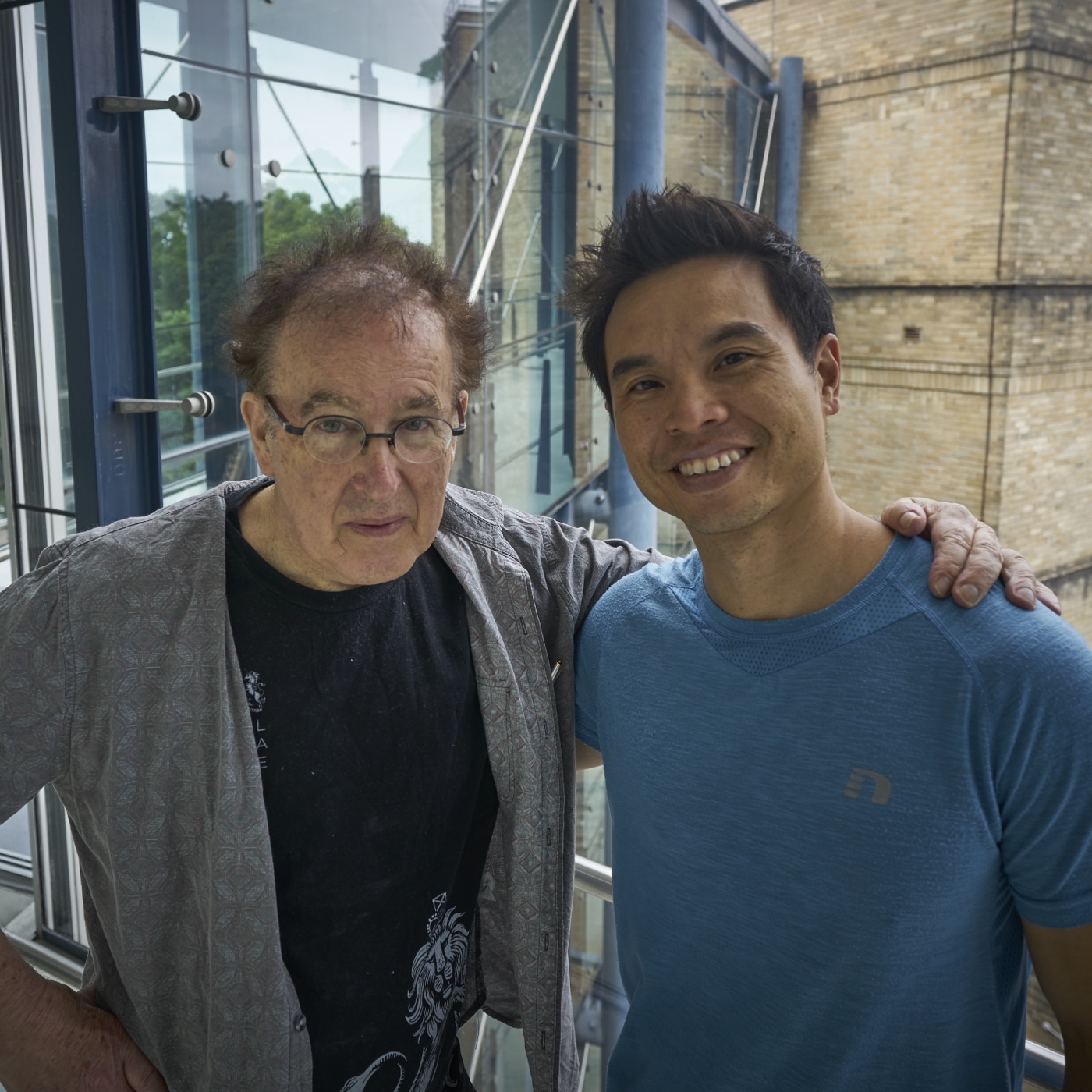Derrick with Bill Pepper, the two of them together at a window, Bill's hand on Derrick's shoulder