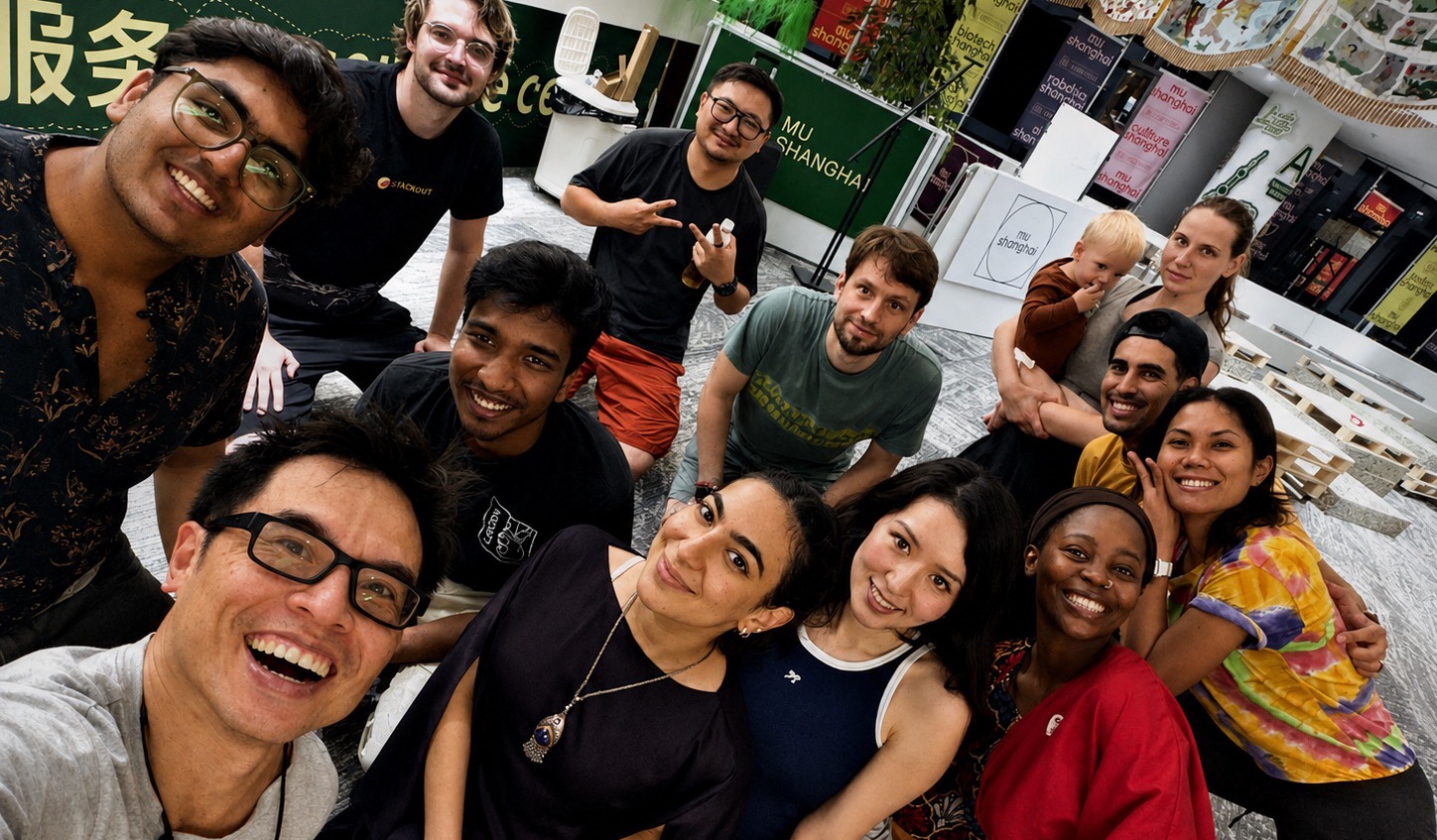 Fourteen people at a Human Labb session in Shanghai, crowded together and smiling at the camera